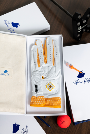Top-down view of the Raiu edition premium golf glove and luxury unboxing kit, emphasizing the 'Thunder' theme and the elite quality of Alpine Golf's limited release.